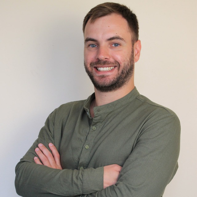 Portrait of a smiling RADBOR Growth Agency team member with arms crossed